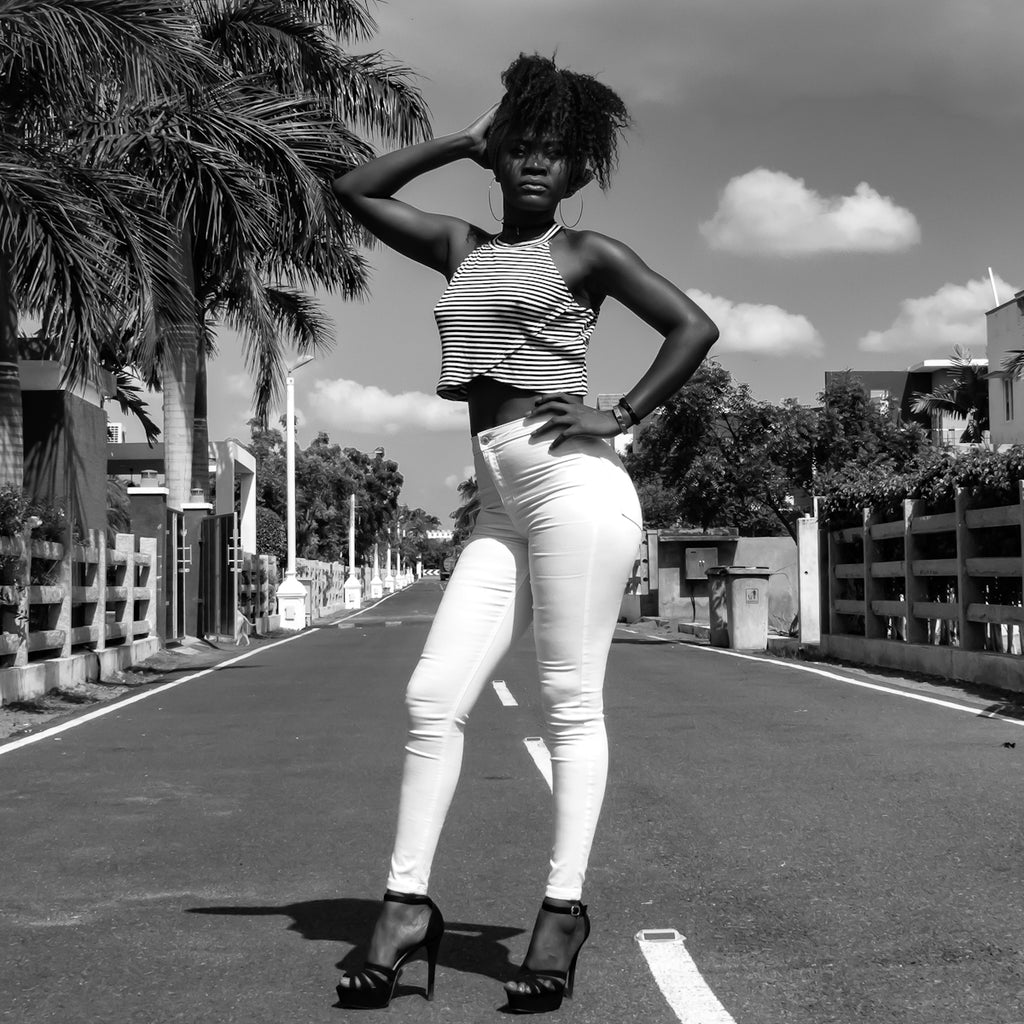 greyscale photo of woman standing on road