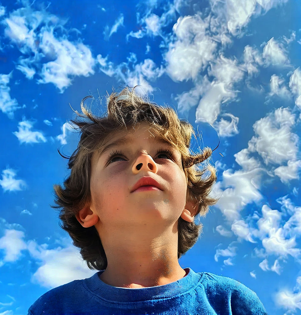 A young boy looking up into the sky