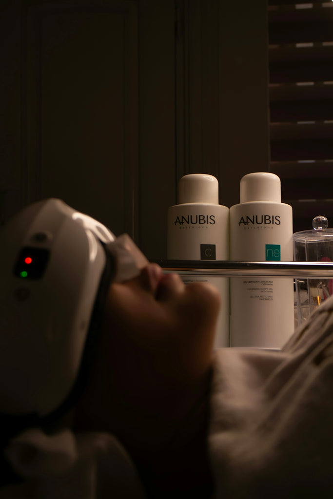 Woman receiving facial treatment with beauty products