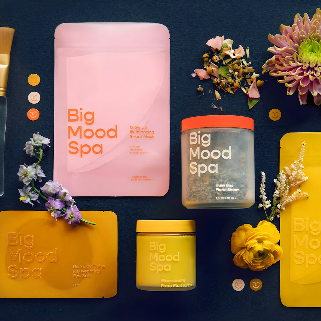 Spa products and flowers arranged on dark surface.