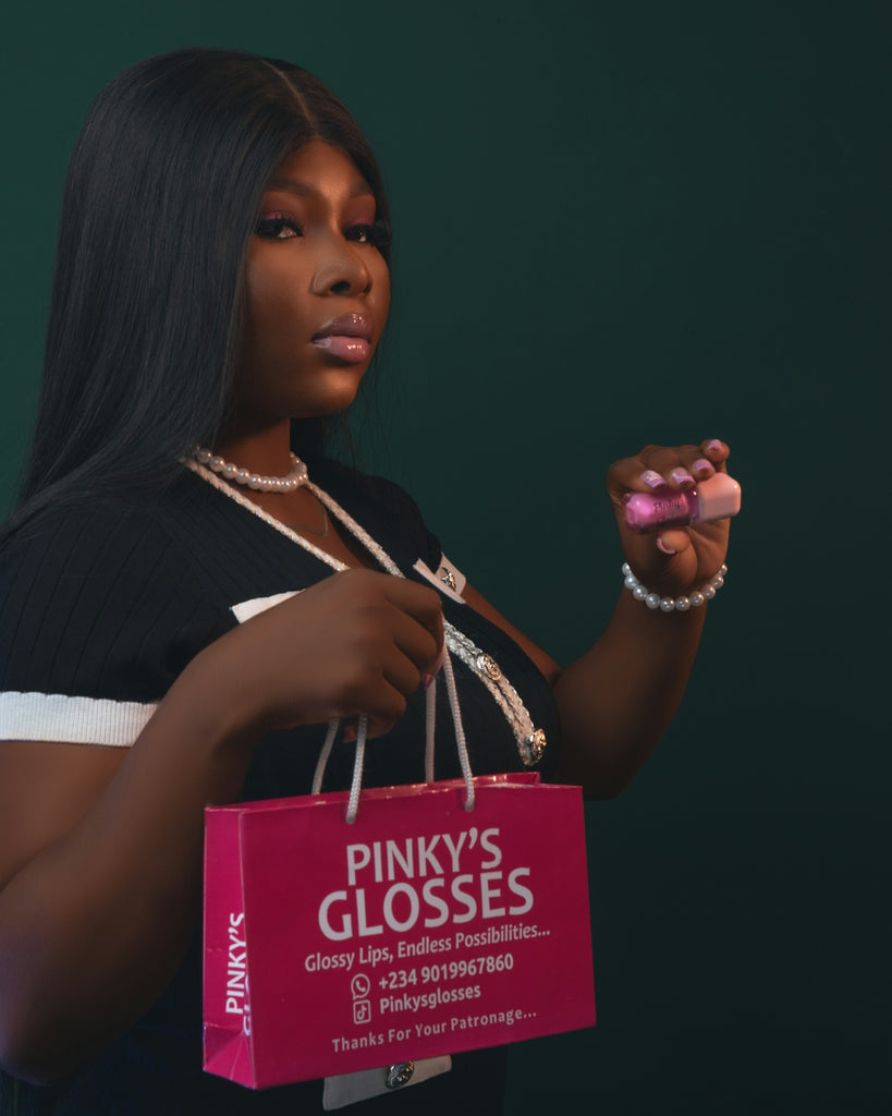 Woman holding a pink shopping bag with makeup