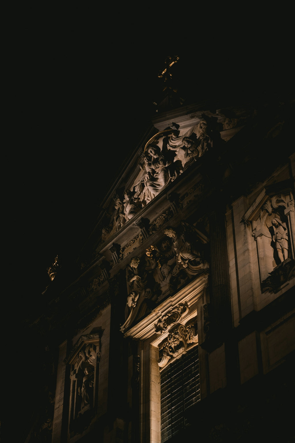 Ornate church facade illuminated at night