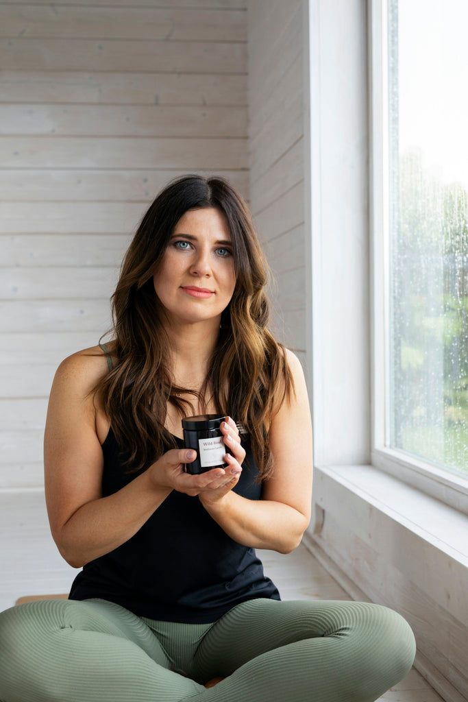 Woman holding a jar by the window