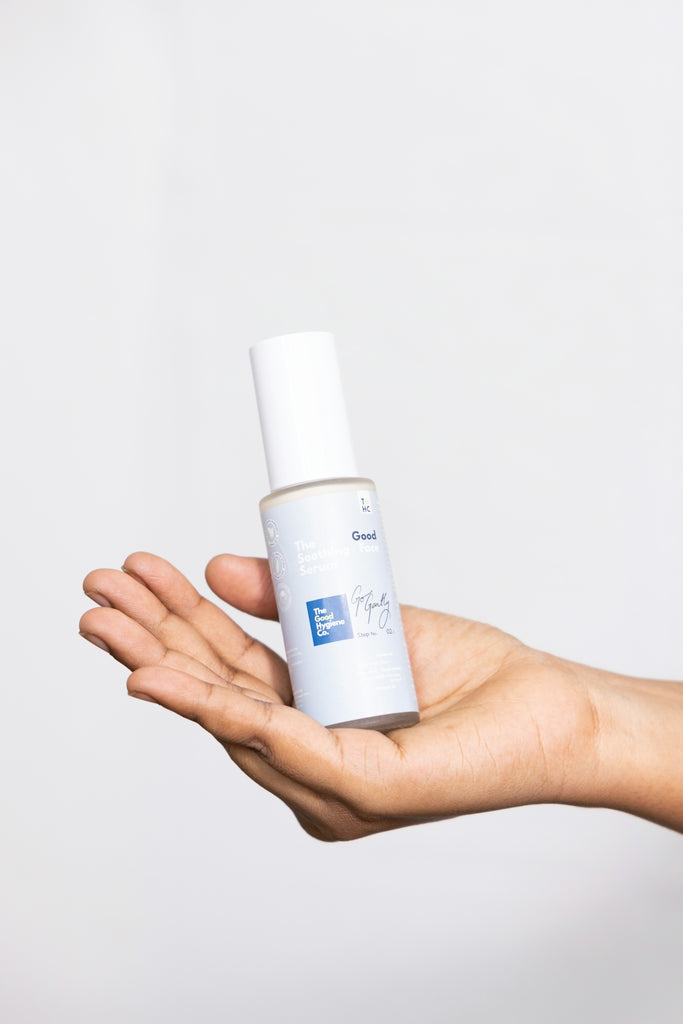 Hand holding a bottle of skincare product