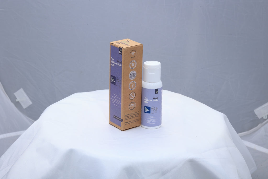A small bottle and box on a white surface.